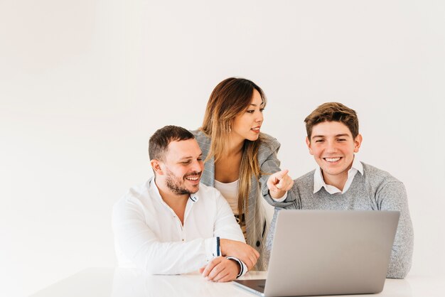 colleagues teaching trainee in office