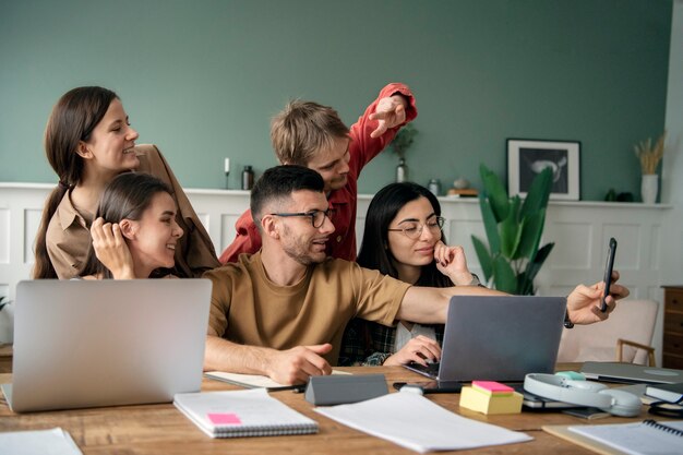 Colleagues using laptops and notebooks for learning in a study session