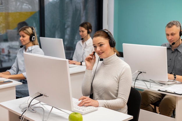 Colleagues with headphones working in a call center office
