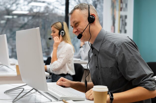 Colleagues working together in a call center office with coffee