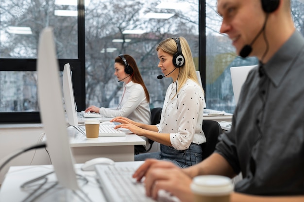 Colleagues working together in a call center office with coffee