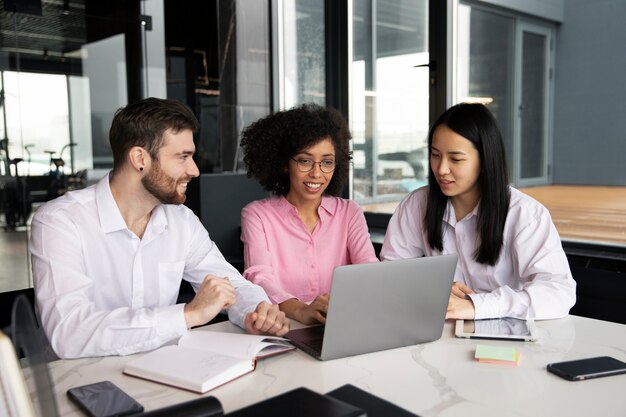 Colleagues working together on a laptop and documents