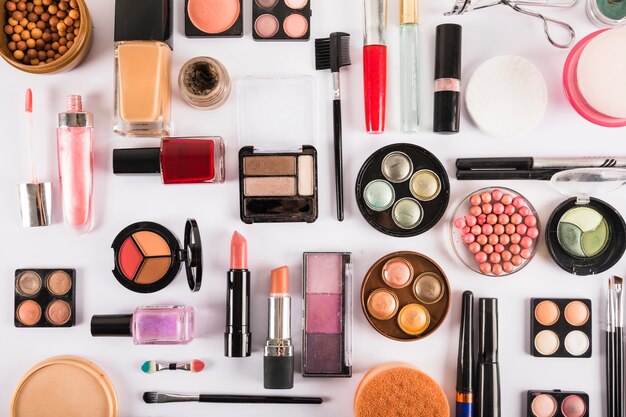 Collection of cosmetic beauty products on white backdrop