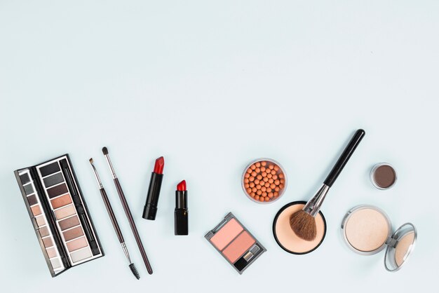 Collection of makeup accessories on light background  