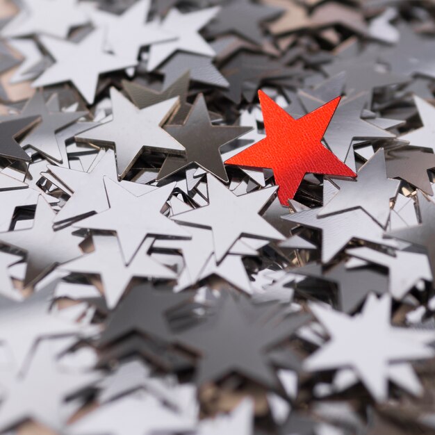 Collection of silver stars surrounding a red one