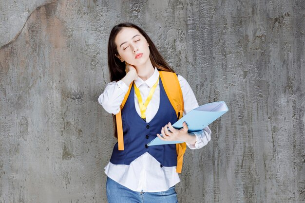 College student in uniform with folder sleeping. High quality photo