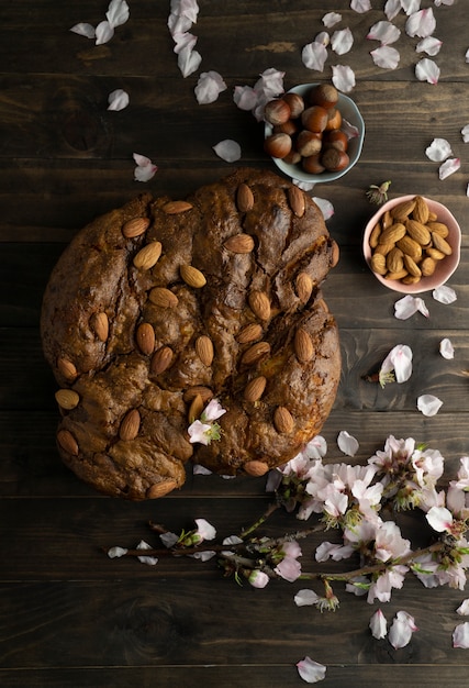 Colomba with almonds and flowers flat lay