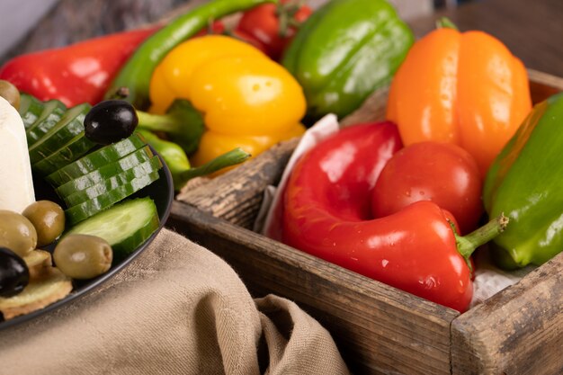 Color chili peppers mix in a rustic tray