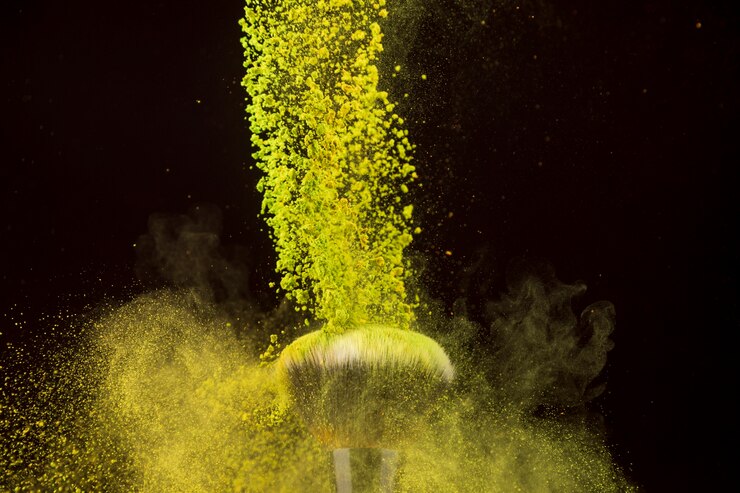 Free Photo color powder cascade falling on foundation brush
