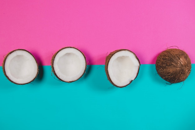 Free photo colored background with coconuts