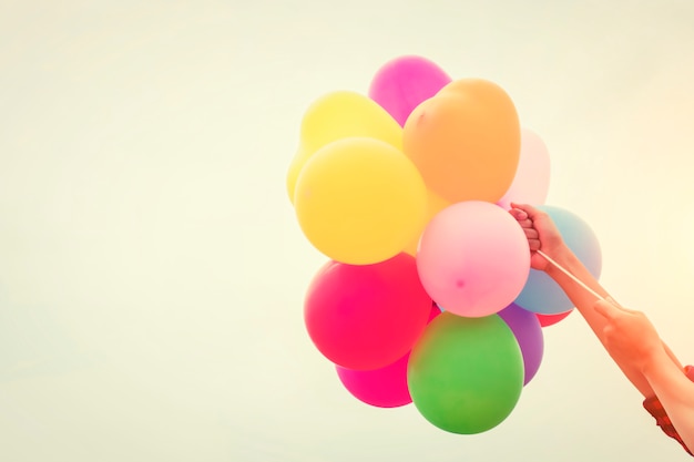 Colored balloons held by arms