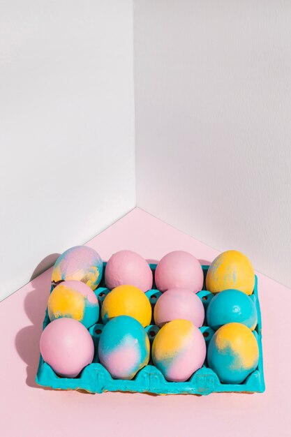 Colored Easter eggs in big bright rack on table