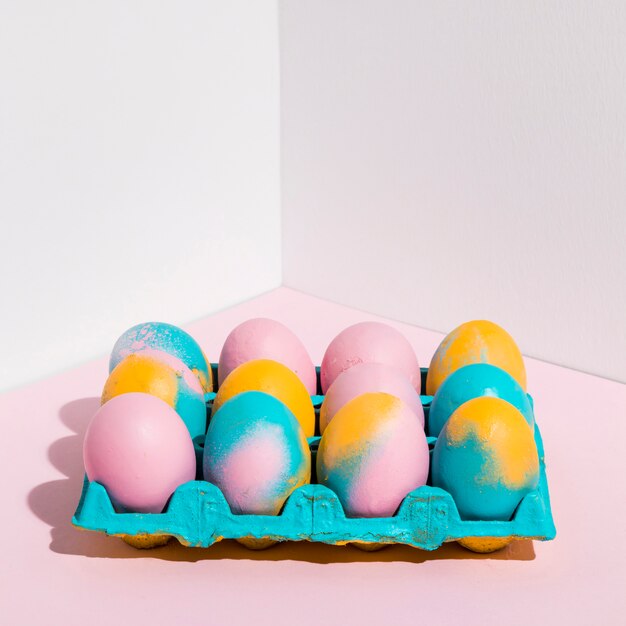 Colored Easter eggs in bright rack on table