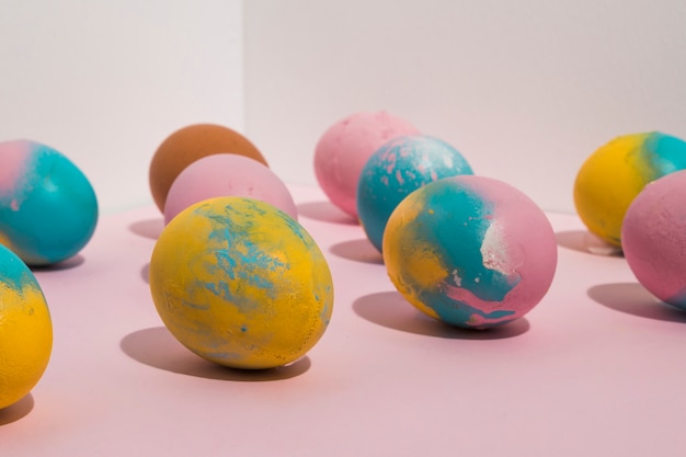 Colored Easter eggs scattered on table