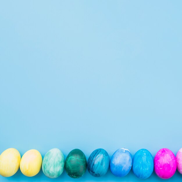 Free photo colored eggs on blue background