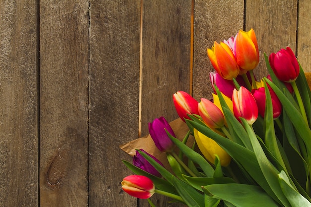 Free photo colored flowers on wooden surface for father's day