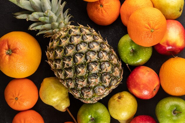 Colored fruits ripe juicy mellow on a grey desk