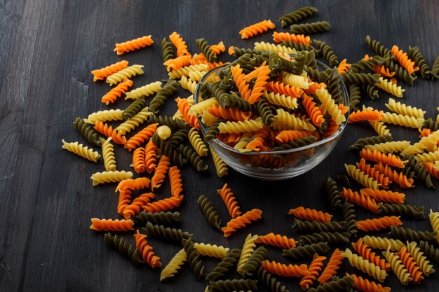 Colored fusilli pasta in a glass bowl