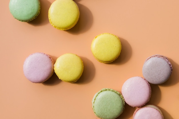 Colored macaroons on colored background
