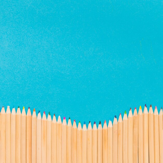 Free photo colored pencils on blue background