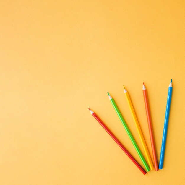 Colored pencils on orange background