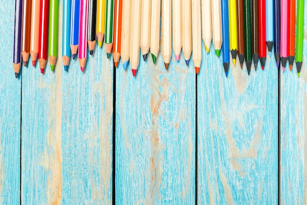 Free photo colored pencils on a wooden board