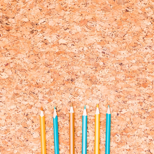 Colored pencils on wooden table