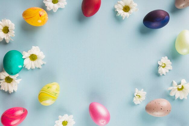 Colored quail eggs near flowers