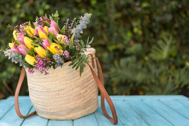 Free photo colored tulips in a handbag