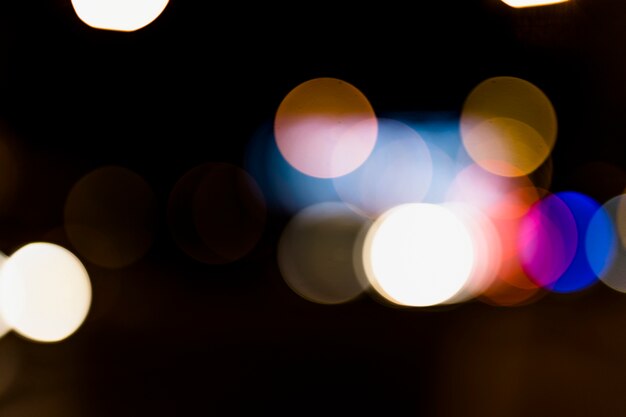 Colorful abstract bokeh background on dark backdrop