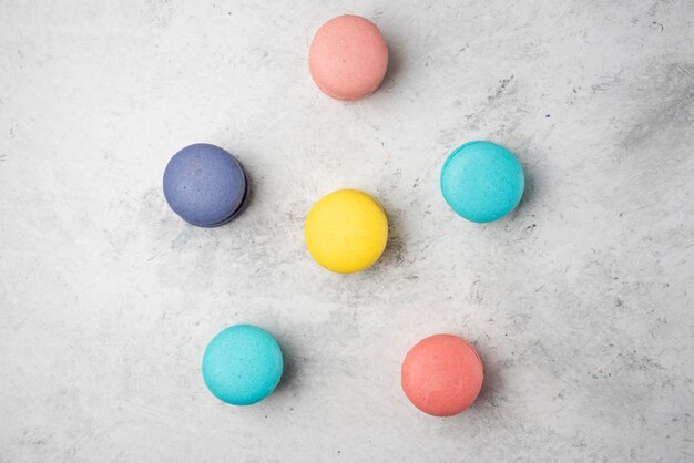 Colorful almond macarons on white surface. Top view.