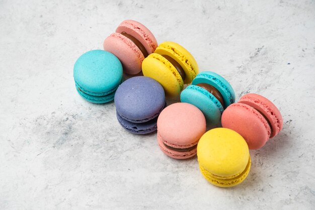 Colorful almond macarons on white surface. Top view.
