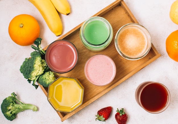 Colorful arrangement of smoothies and fruits