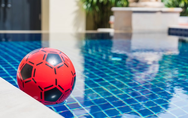 Free photo colorful ball floating in a swimming pool