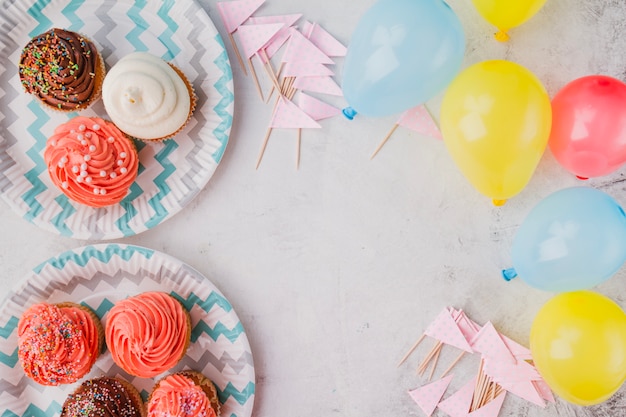 Free photo colorful balloons and muffins