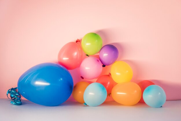 Colorful balloons on pink background