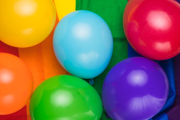 Colorful balloons on rainbow flag