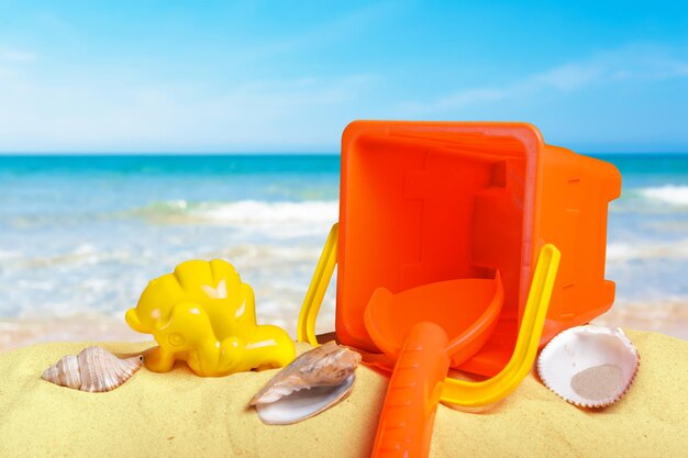 Colorful beach toys on sand