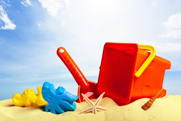 Colorful beach toys on sand