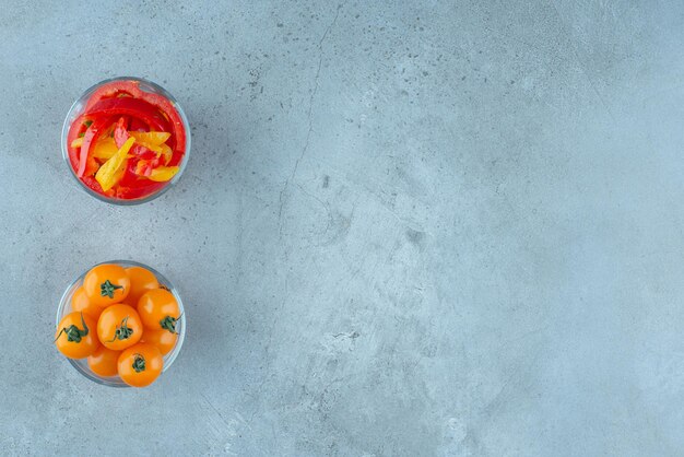 Colorful bell pepper salad and cherry tomatoes in glass cup.