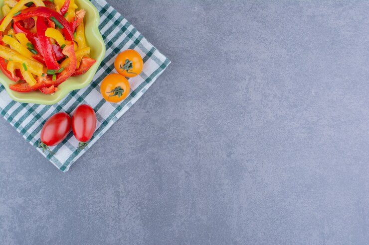 Free Photo colorful bell pepper salad with cherry tomatoes on blue surface