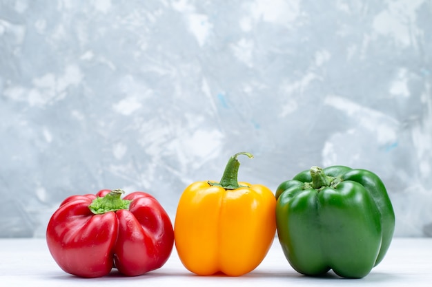 colorful bell-peppers lined on white desk, vegetable spice hot food meal ingredient product