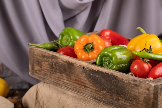 Colorful bell peppers in a rustic tray