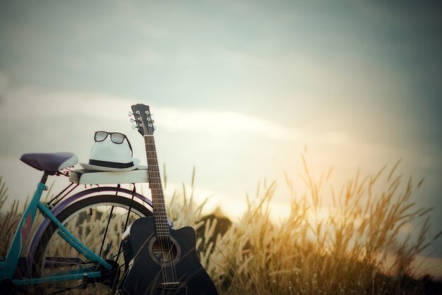 Colorful of Bicycle with guitar  in meadow