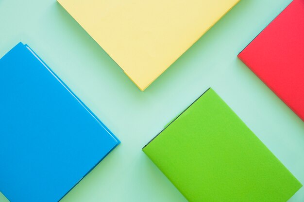 Colorful books on mint background 