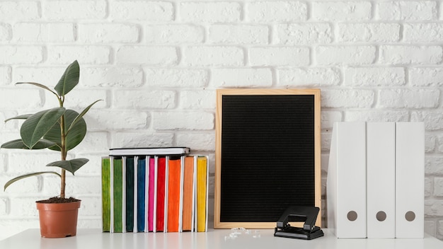 Free photo colorful books and plant on table