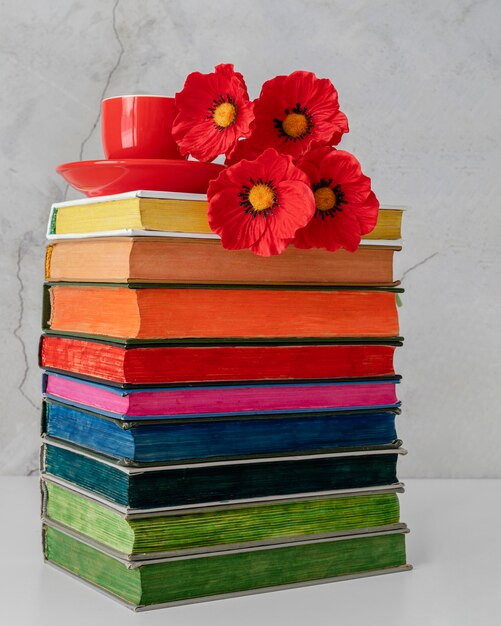 Colorful books stack with flowers