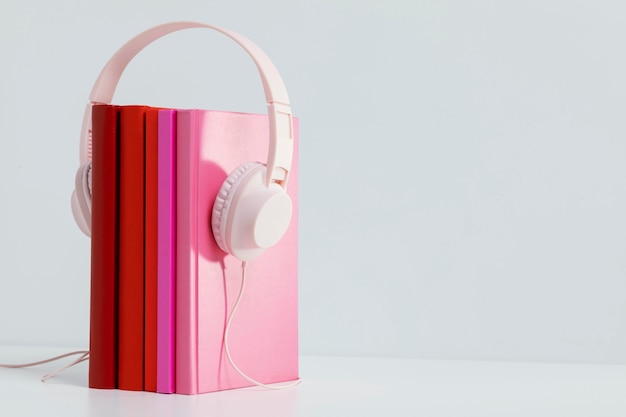 Colorful books with headphones and copy space