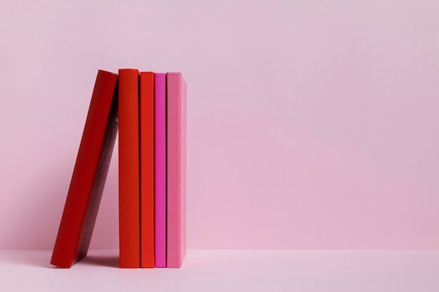 Colorful books with pink background
