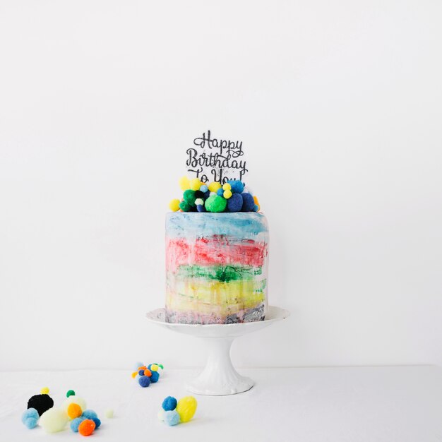 Colorful cake decorated with stones and writing